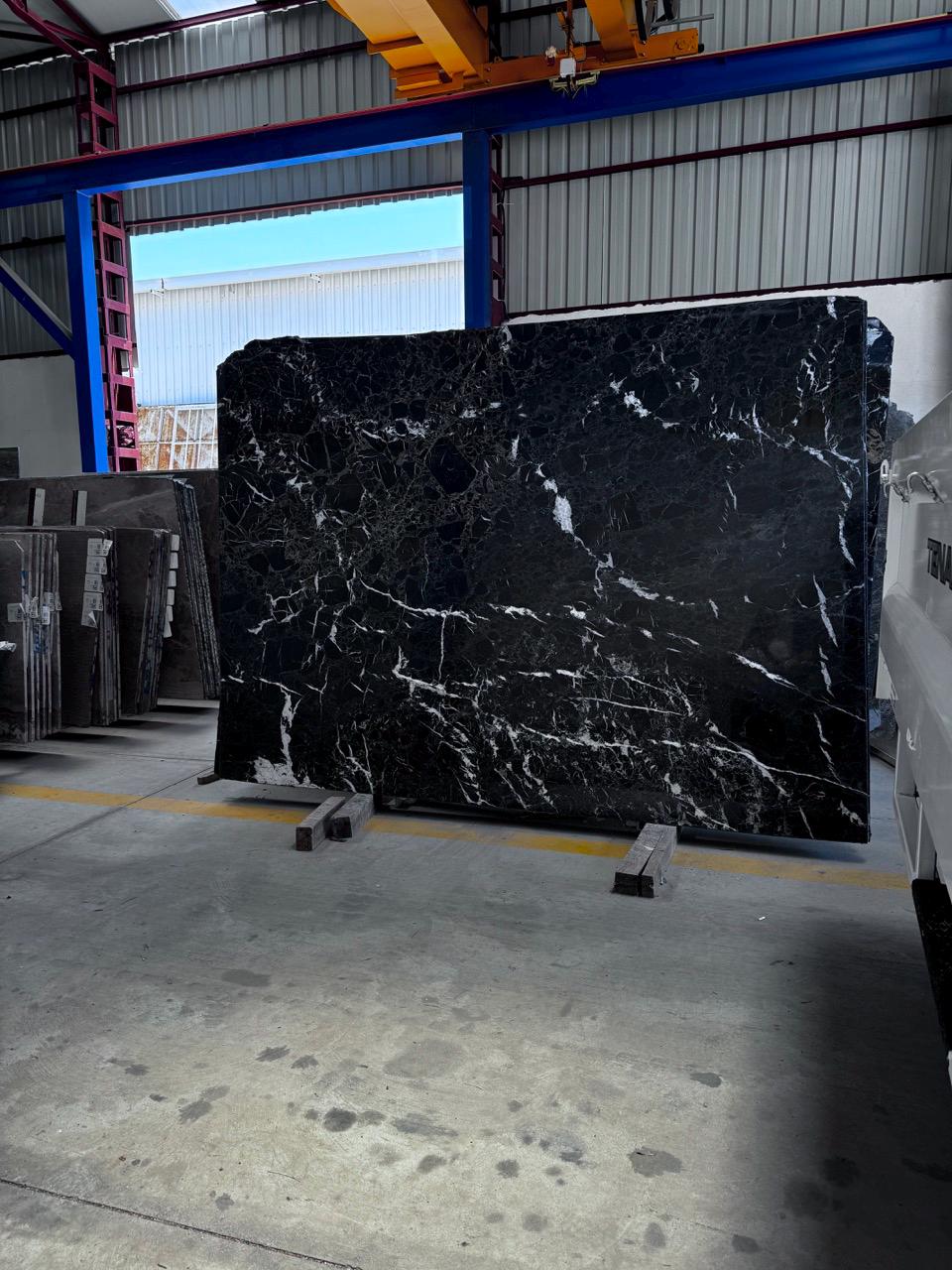 Custom black marble fireplace surround with white veining – view 3
